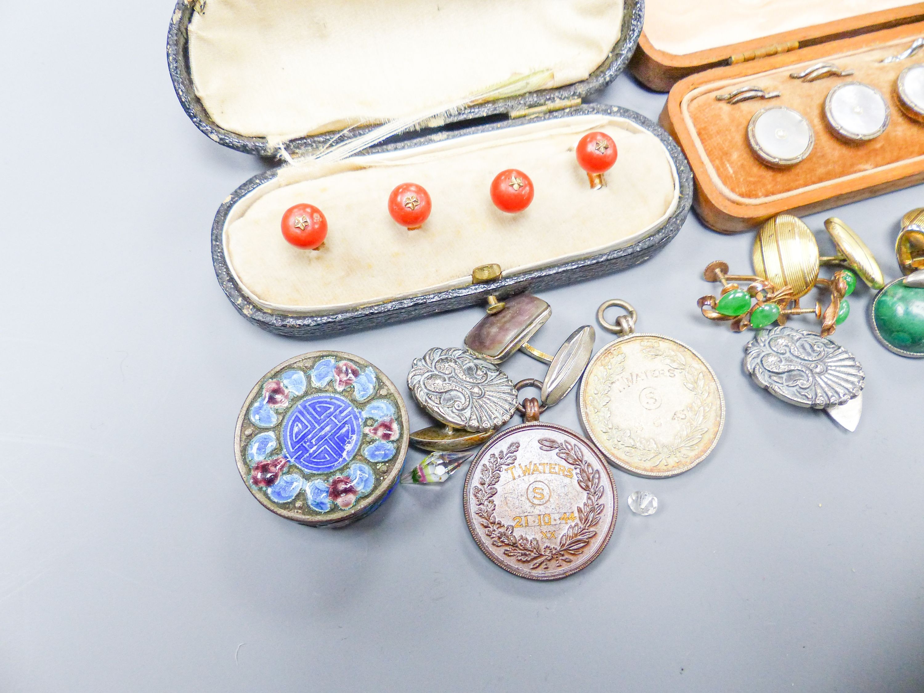 A set of four coral dress studs (cased), a set of six mother of pearl studs (cased), a pair of yellow metal cufflinks, a pair of silver cufflinks and sundry items